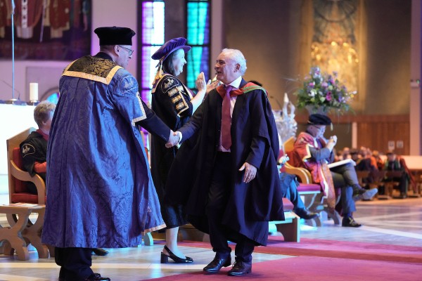 A graduate collects their degree.